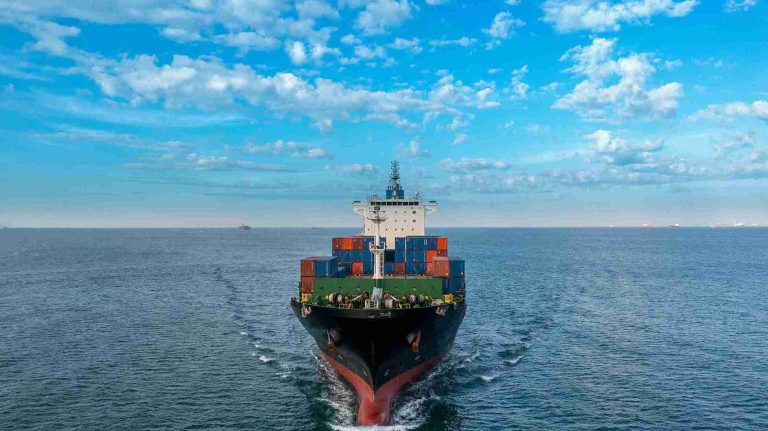 aerial-side-view-of-cargo-ship-carrying-container-2023-11-27-04-56-43-utc_11zon