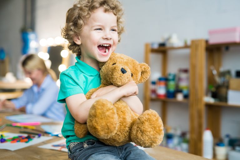 Cute Little Kid Hugging Teddy Bear